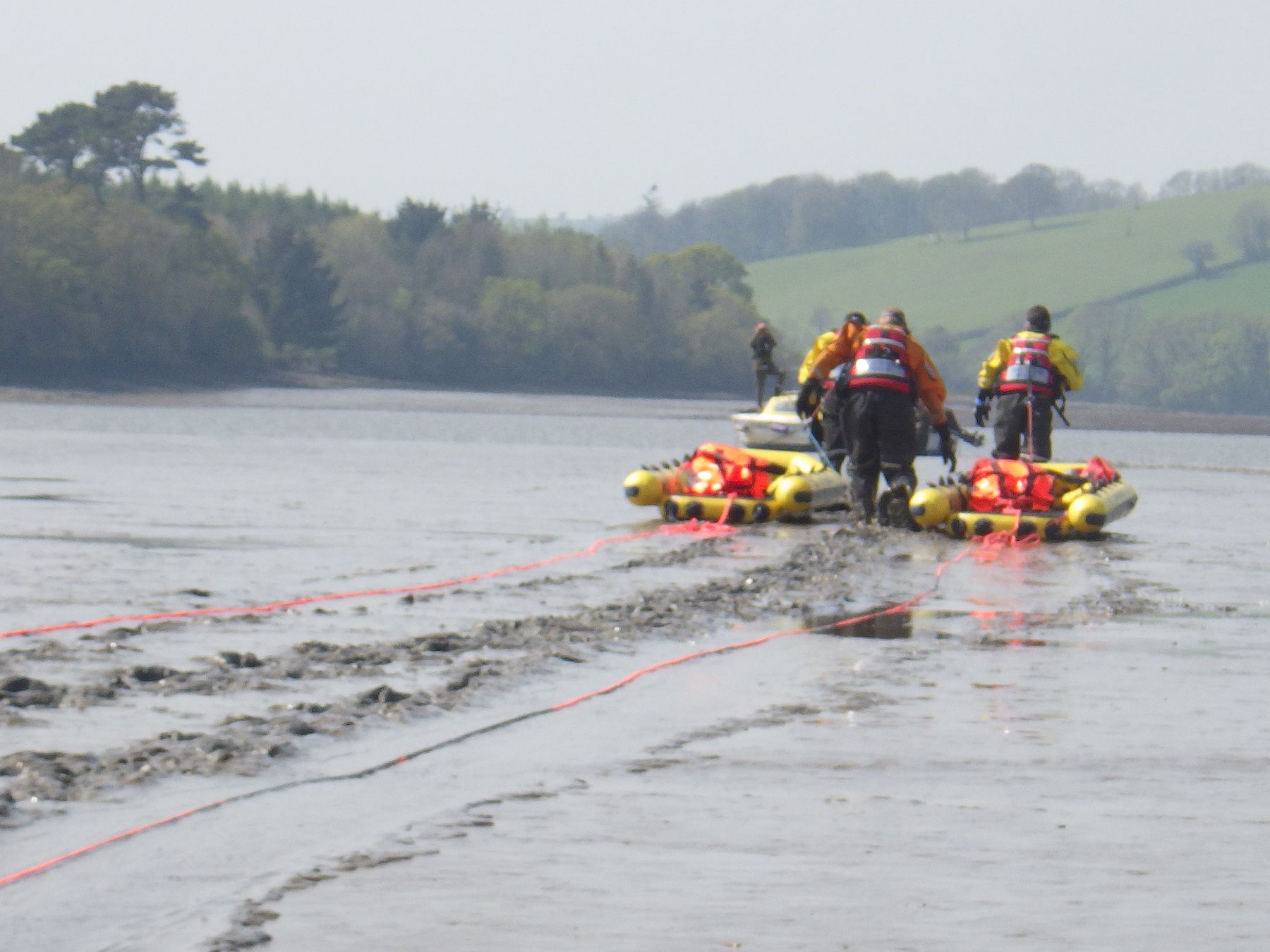 Coastguard technicians take rescue rafts to the vessel