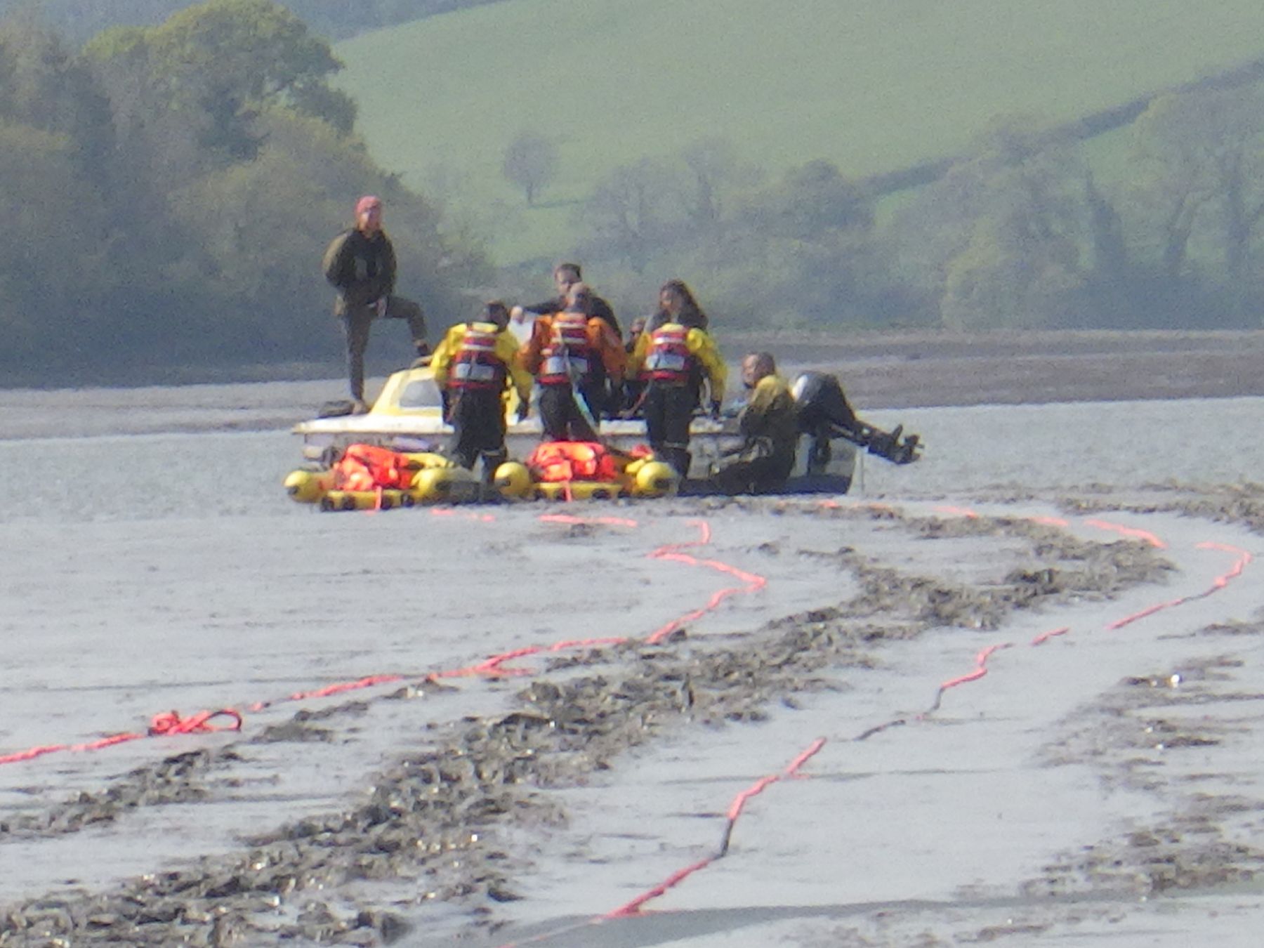Coastguard technicians preparing to embark 3 casualties to a rescue raft.