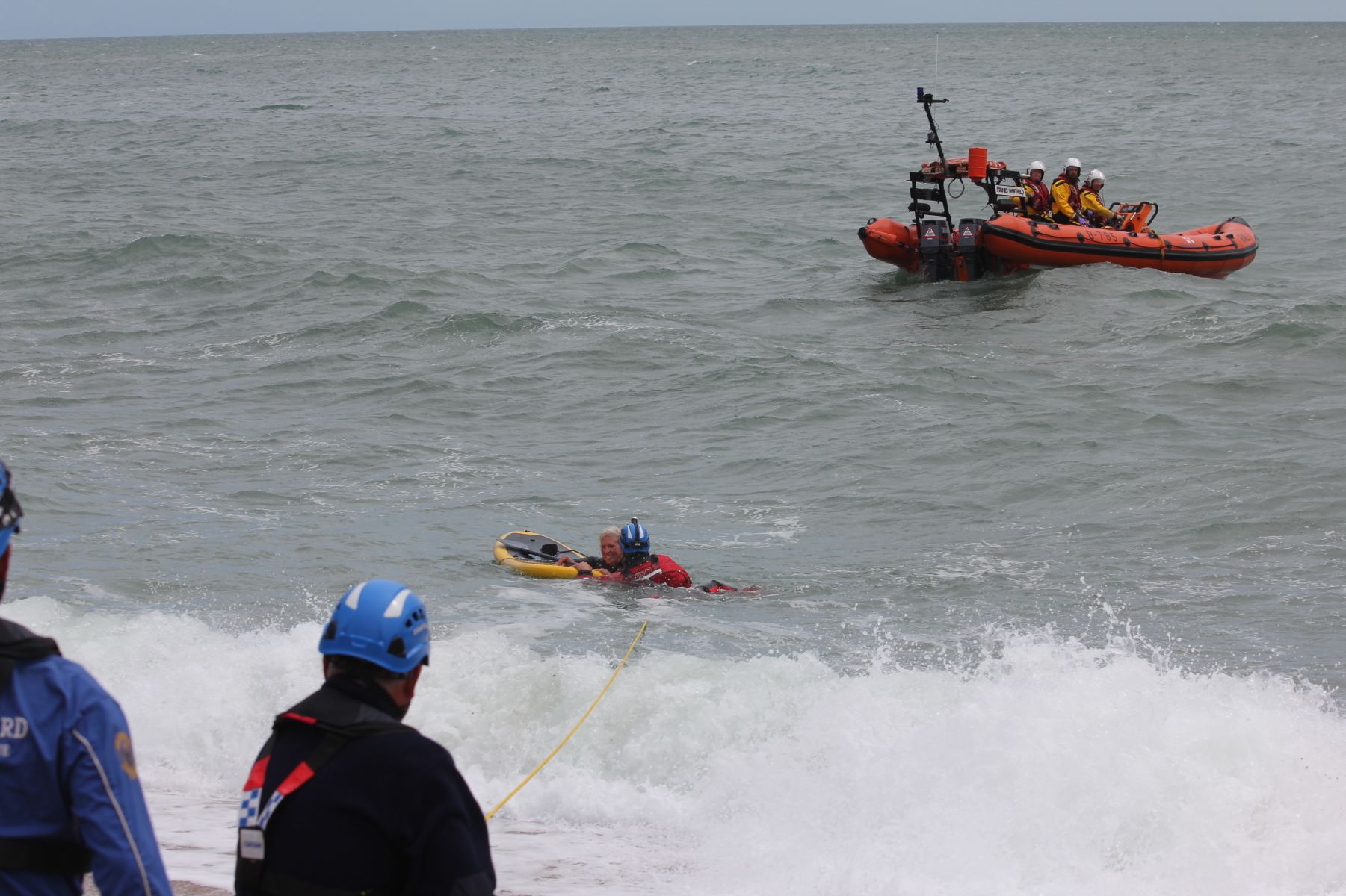 Paddleboarder is helped ashore by the Dartmouth Coastguard team