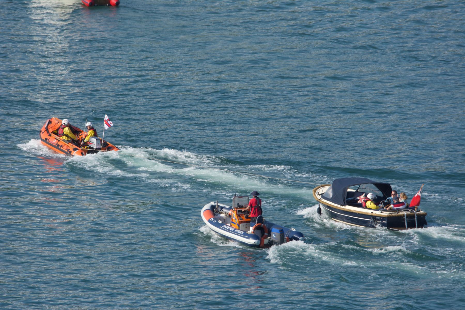 Motor launch being towed back through Dartmouth harbour